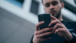 Hombre sujetando un móvil iPhone 13